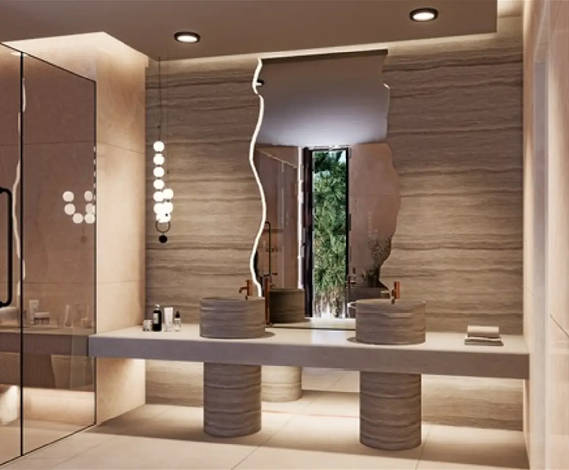 Travertine bathroom with sculpted mirror and twin stone basins, Tilal Al Ghaf, Dubai
